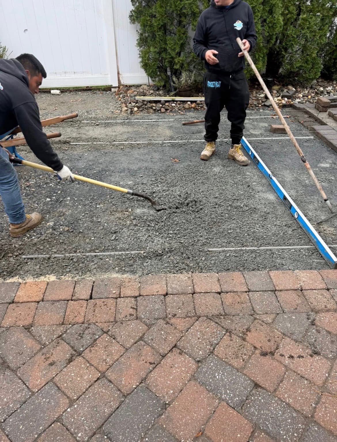 Our crew screeding the base for a paver patio