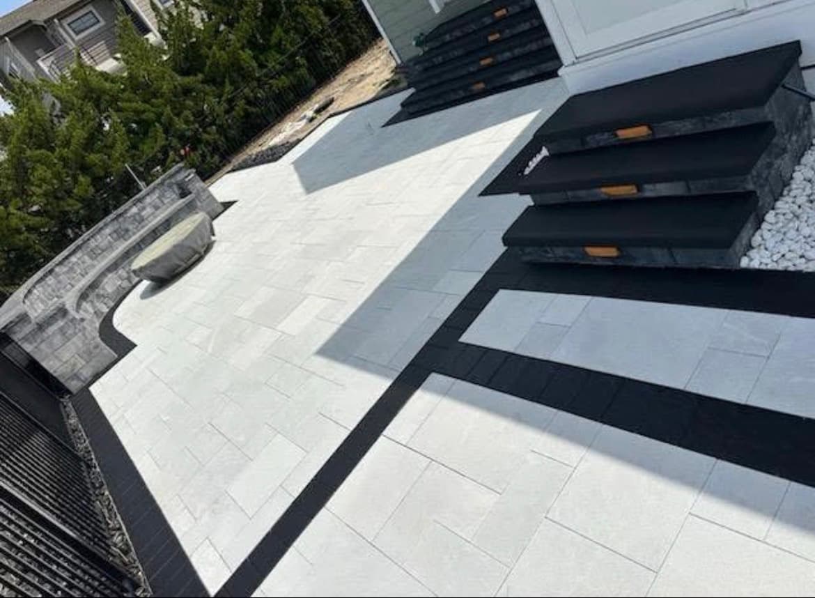 Light paver patio with dark inlay banding