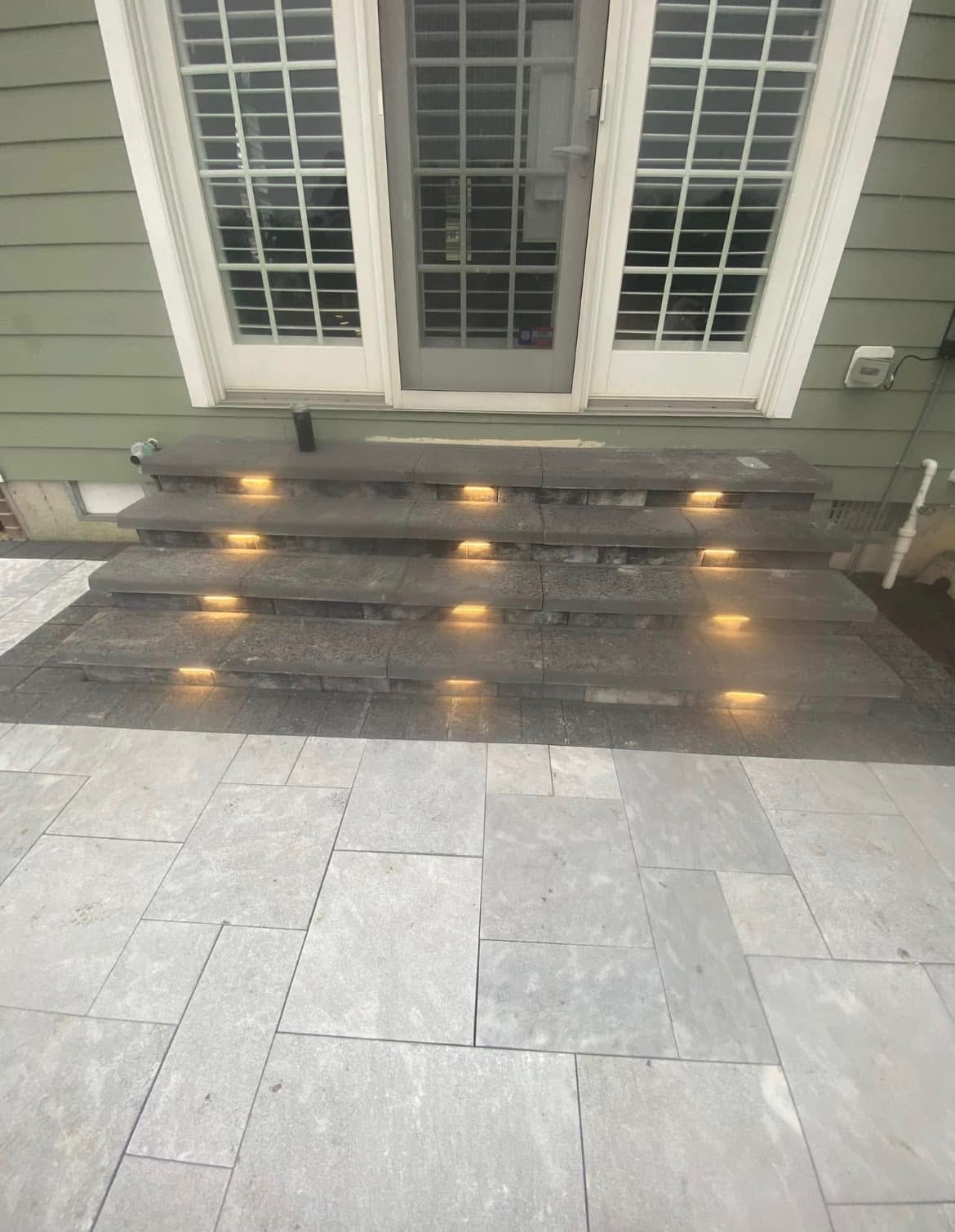 Paver steps with built-in riser lighting